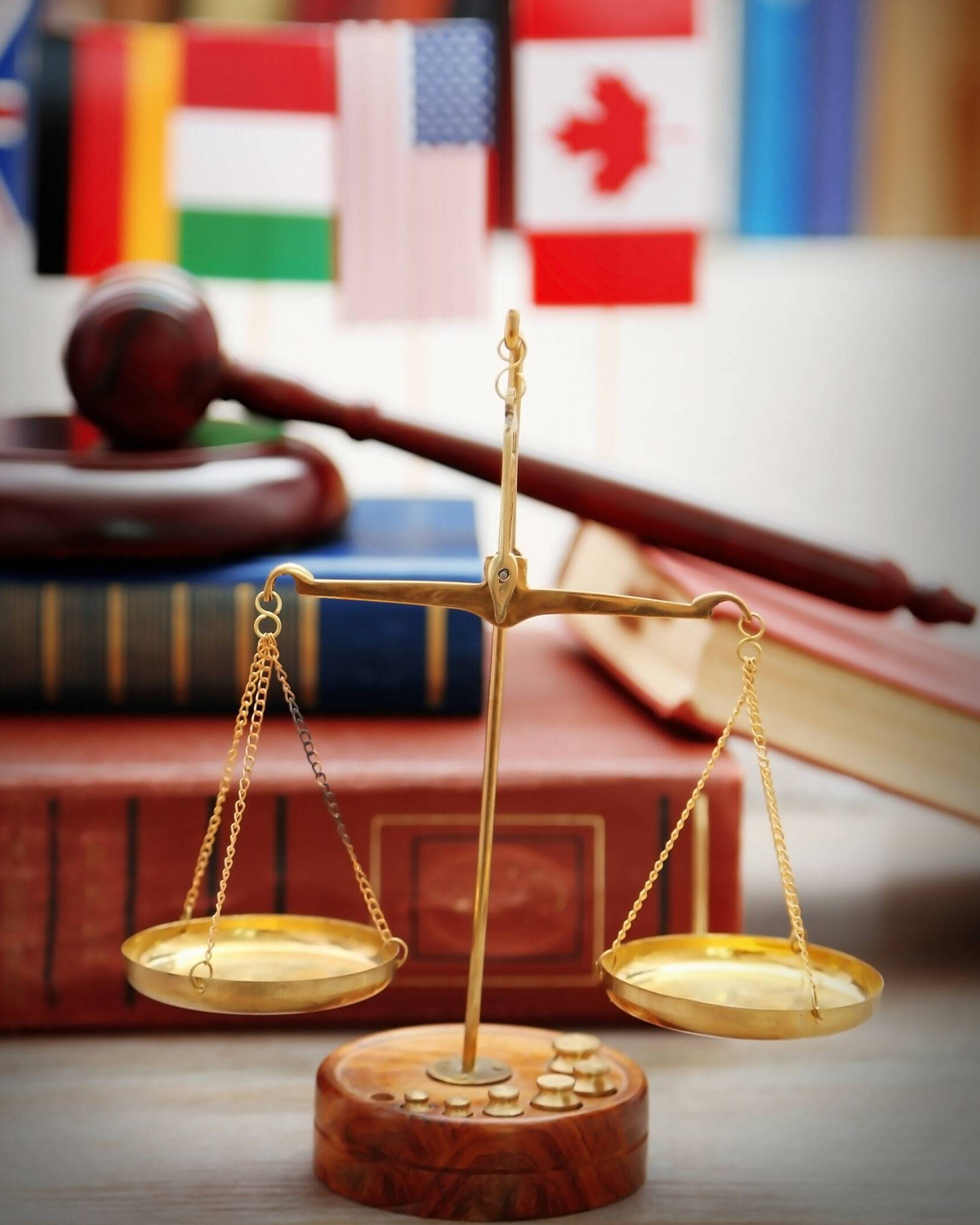 Law concept. Scales of justice with law books on table in a cour